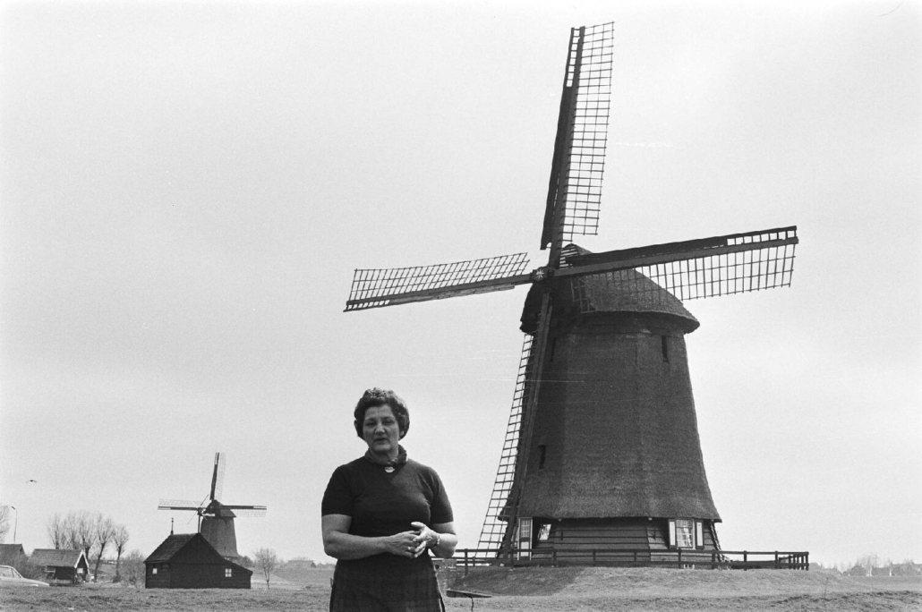 Zwart-wit foto van en vrouw bij een molen in Schermerhorn